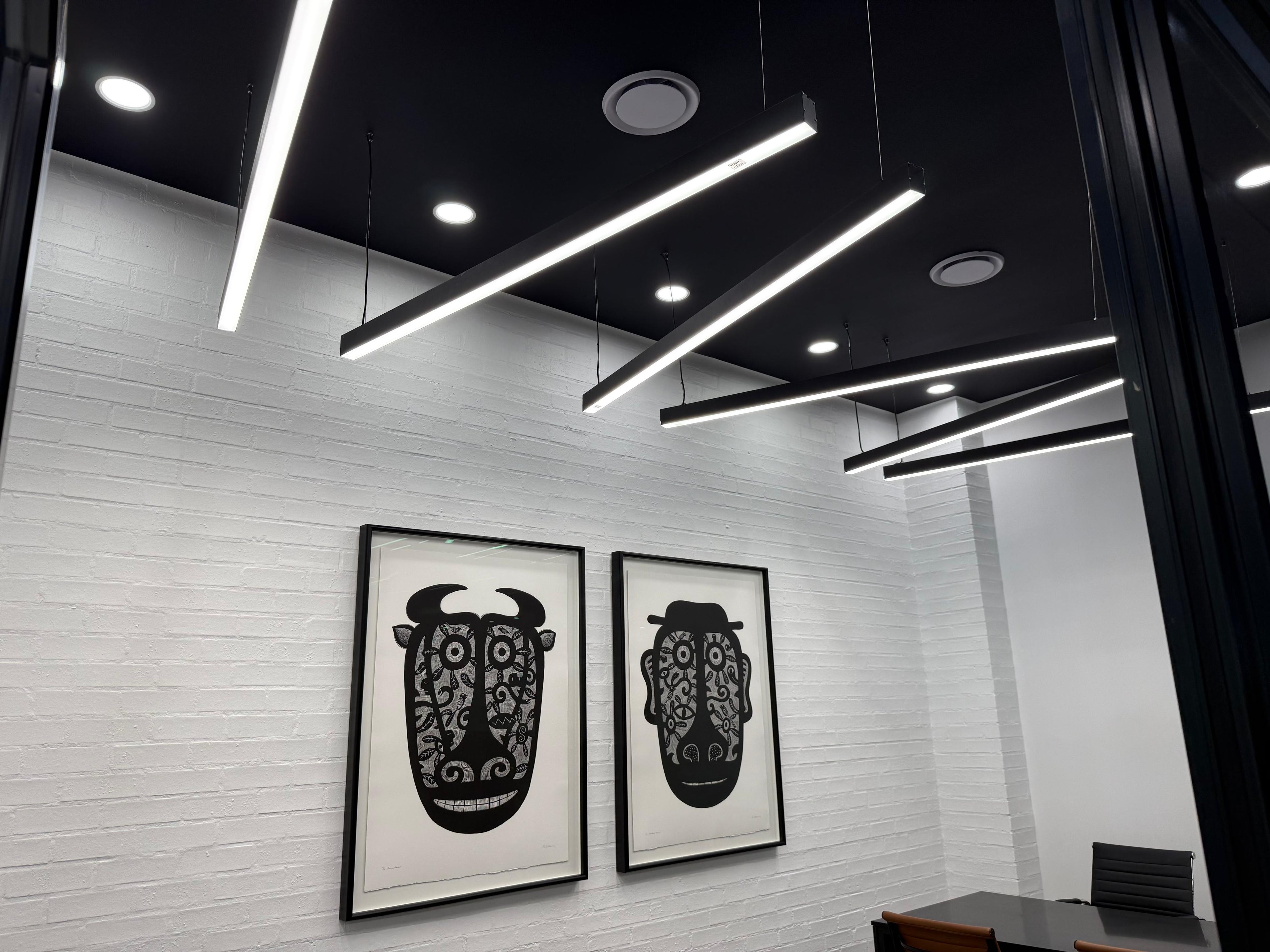 Ceiling-mounted hideaway air conditioning unit installation by Swift Air in a modern corporate office space, featuring energy-efficient ducted cooling.