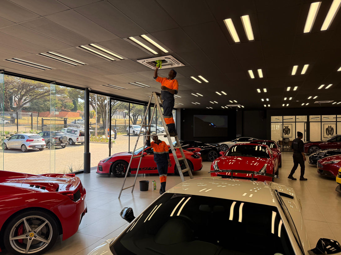 Swift Air technician cleaning a condenser during summer aircon maintenance in Johannesburg