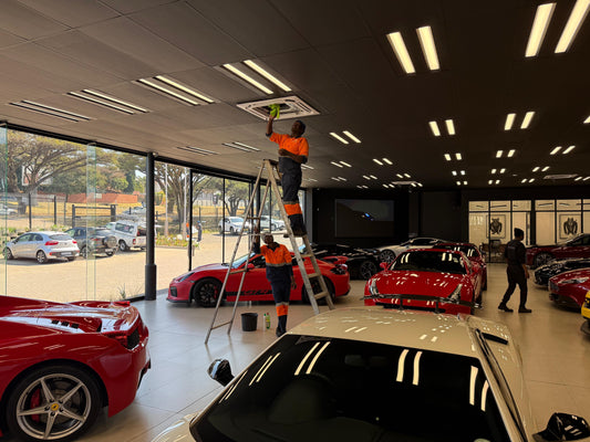 Swift Air technician cleaning a condenser during summer aircon maintenance in Johannesburg